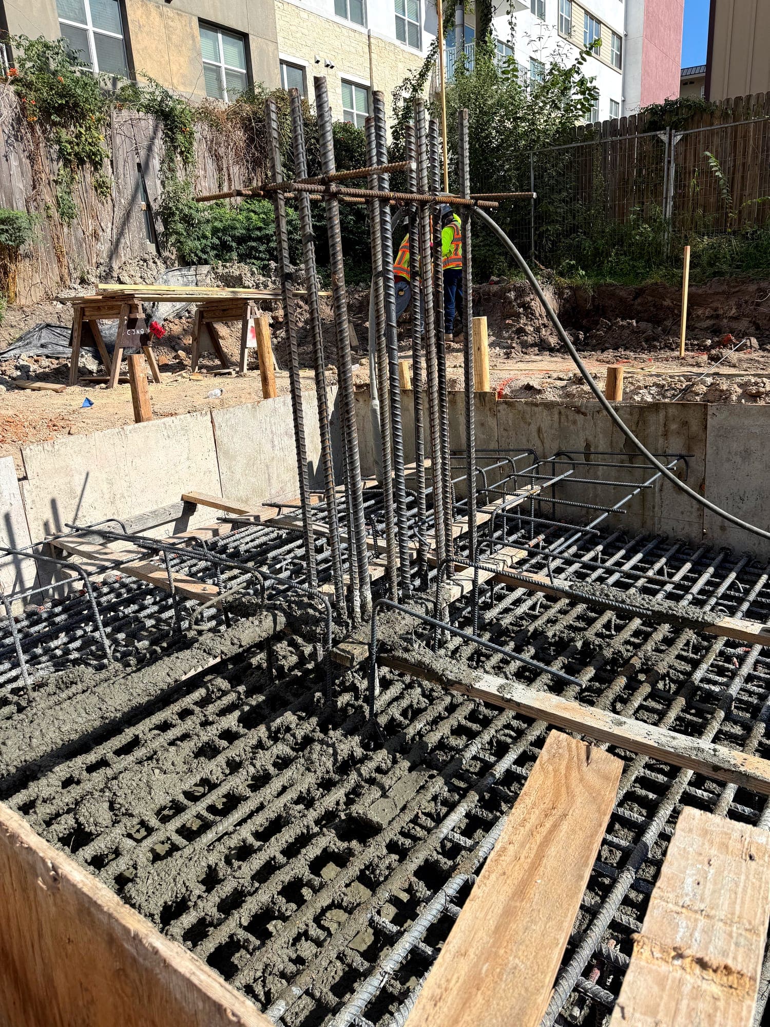 Column reinforcing cage tied into a formed footing