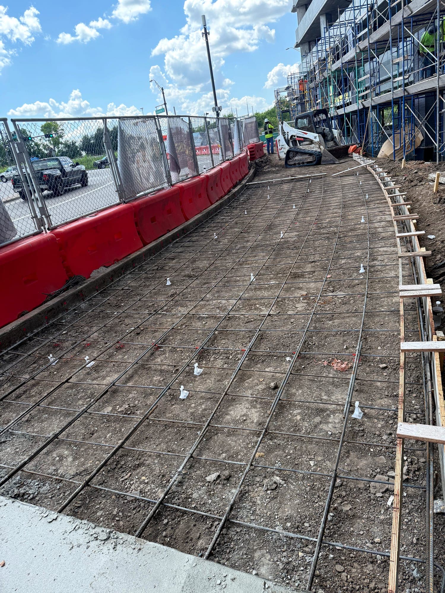 Prepared and formed section ready for concrete paving alongside a roadway
