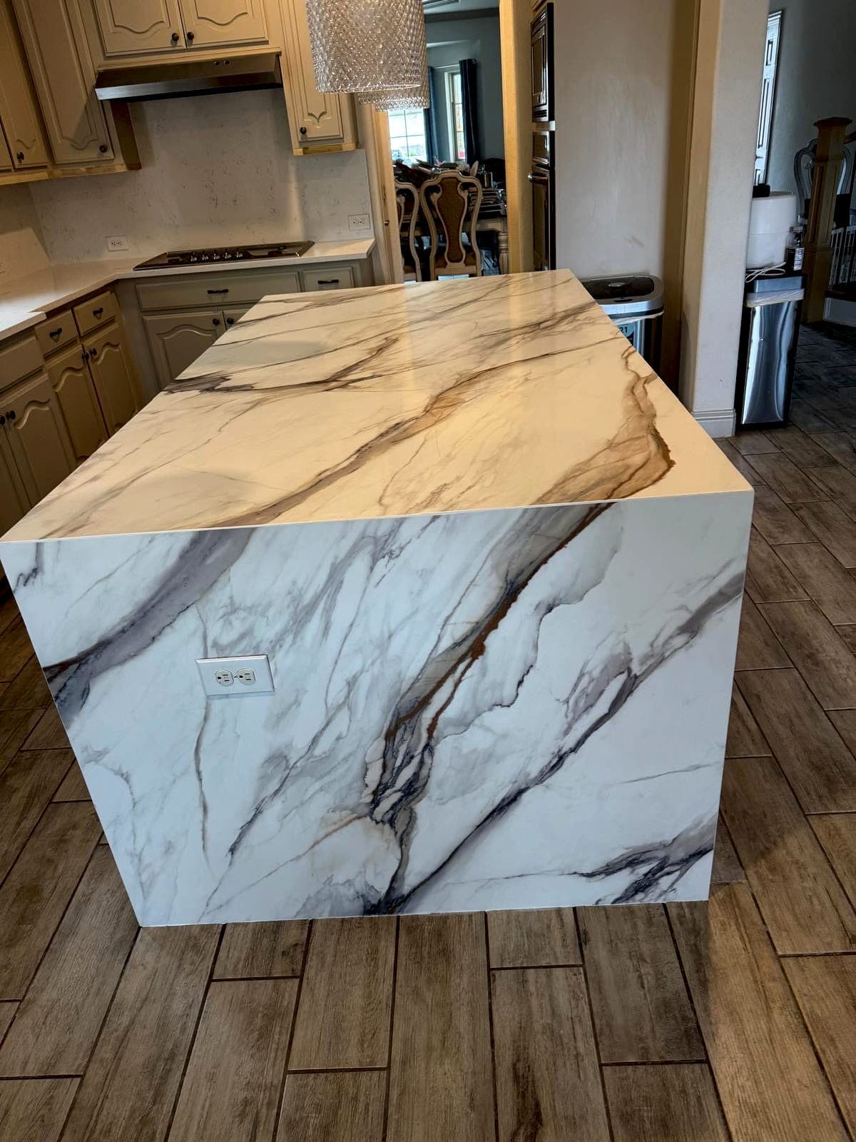 Mitered waterfall edge on a stone island with book-matched veining
