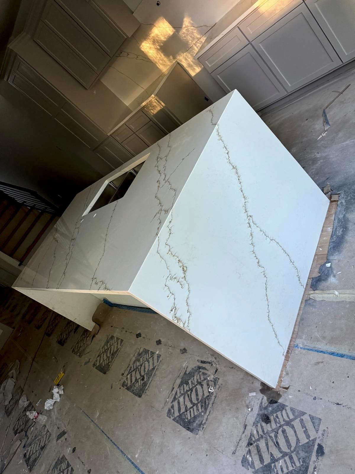 Quartz waterfall-edge island with sink cutout set during installation