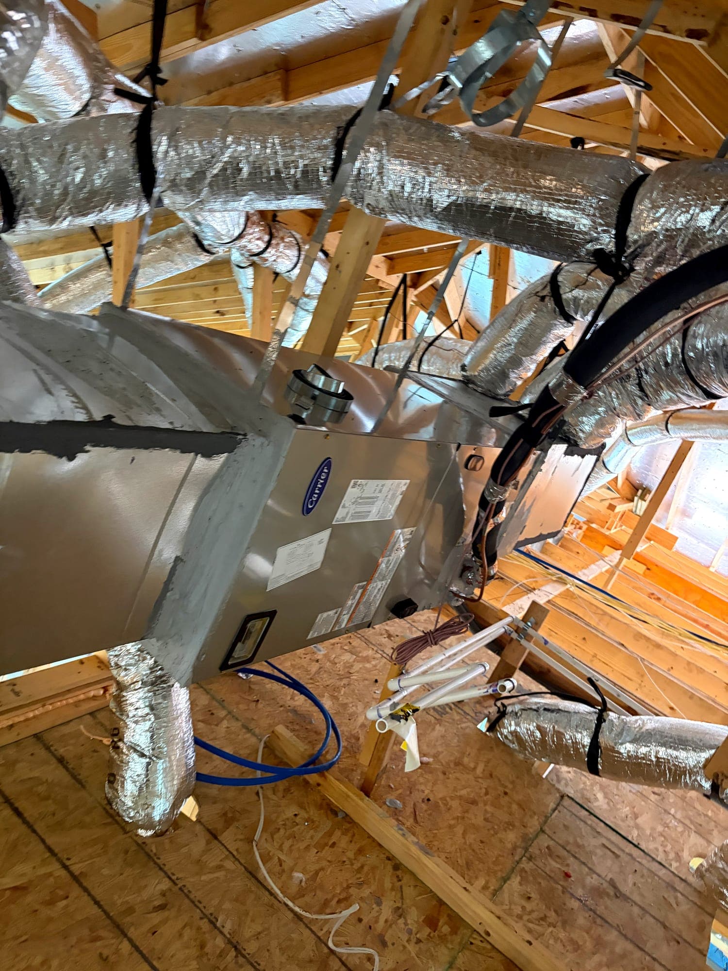 Attic air handler with supply plenum and insulated duct connections