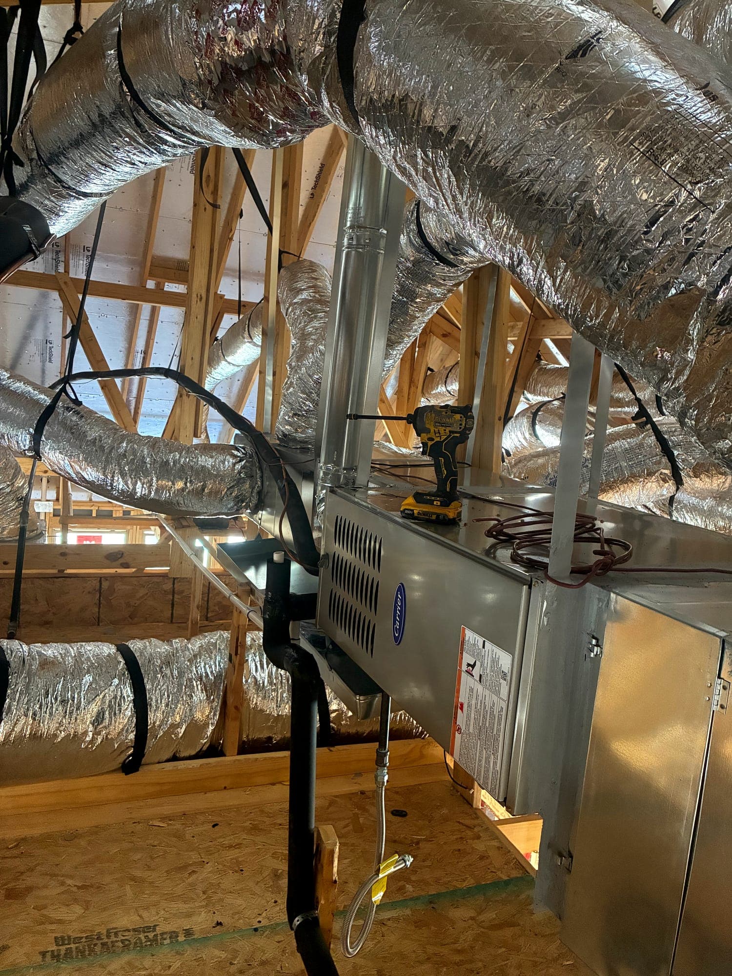 Horizontal air handler installed on an attic platform with duct connections