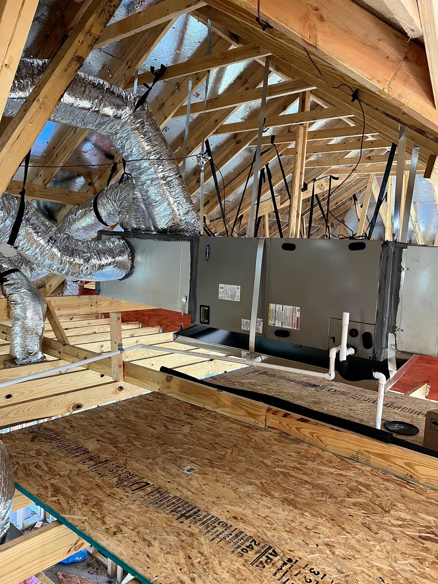 Two air handlers installed side by side on an attic platform