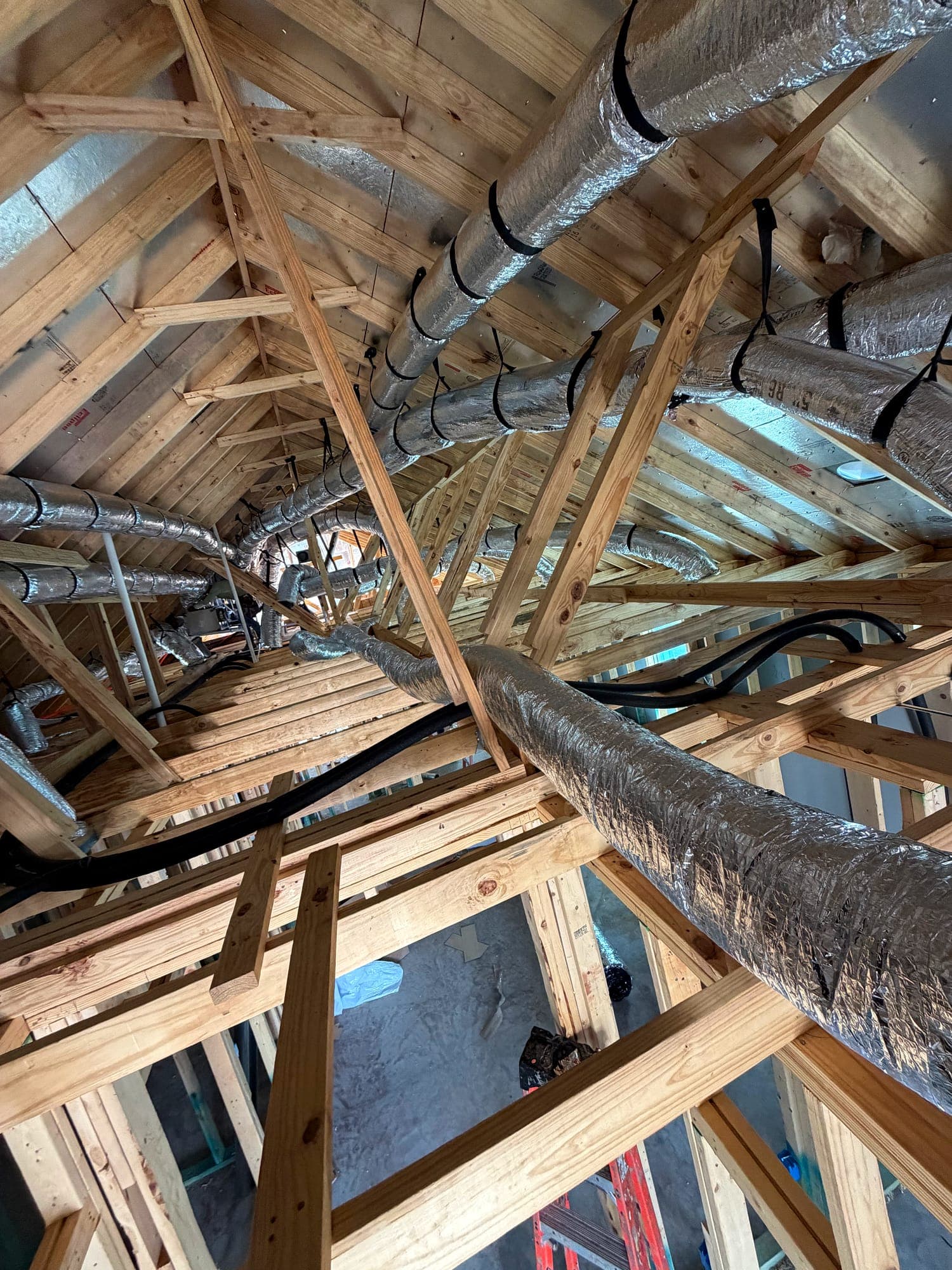 Insulated duct runs routed and supported through attic framing