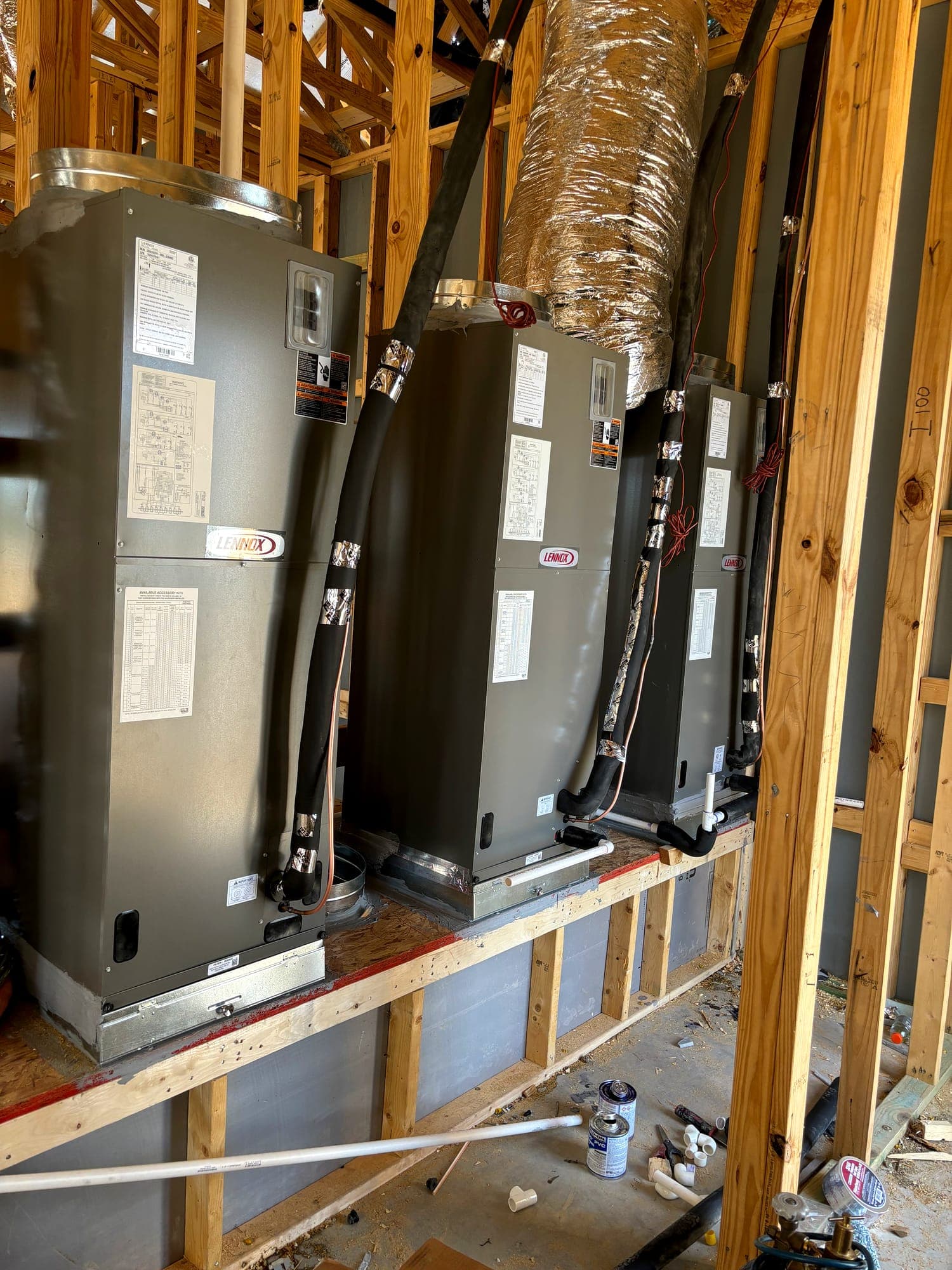 Air handlers and water heaters set on a framed mechanical platform
