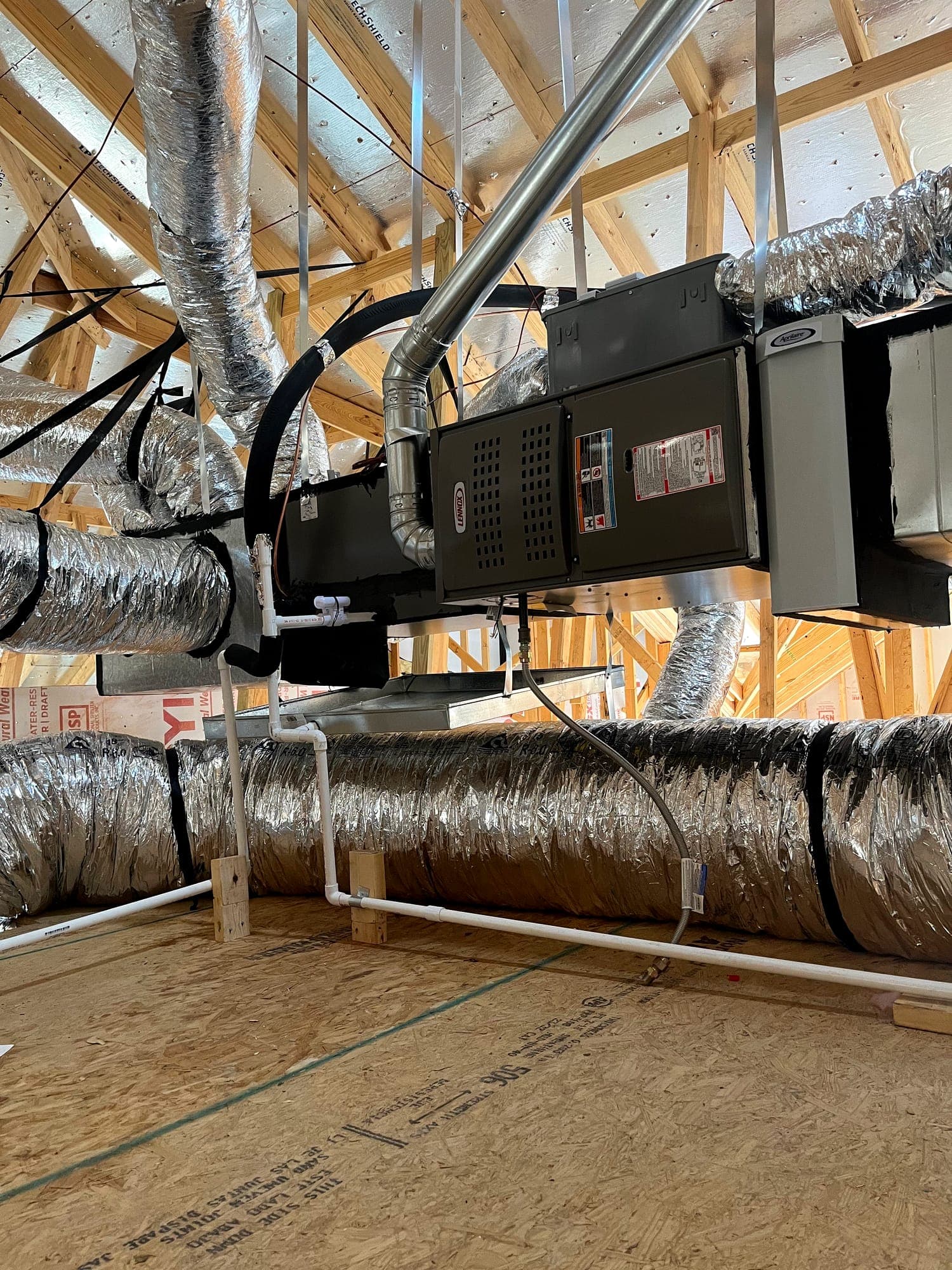 Air handler suspended in framing with duct and electrical connections