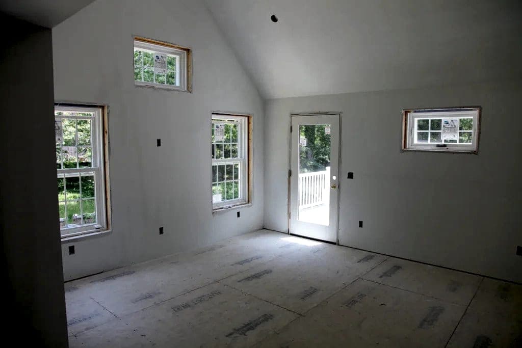 Primed and painted room with clean lines at windows and trim
