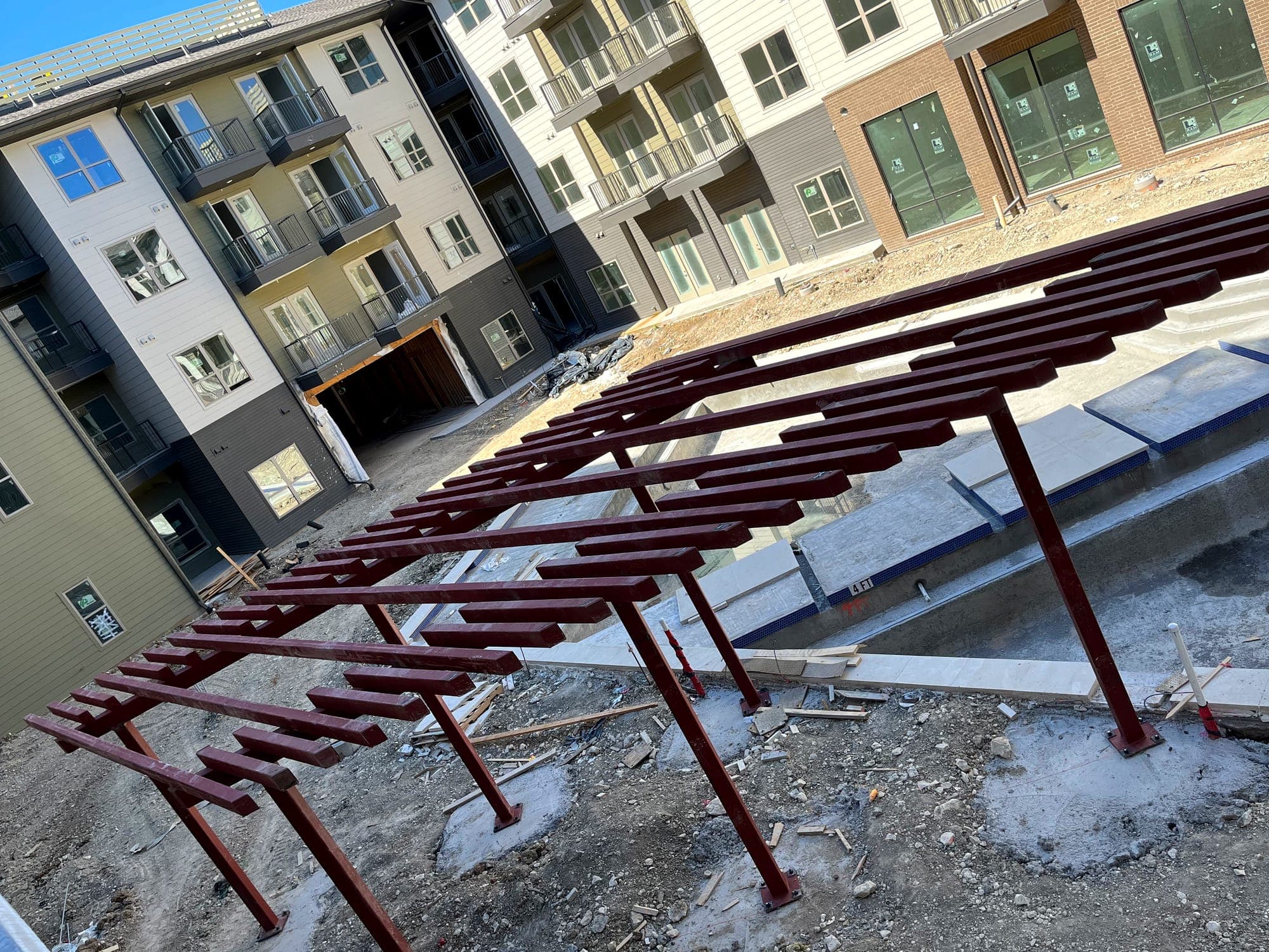 Steel framing installed above a courtyard at a multi-story residential building