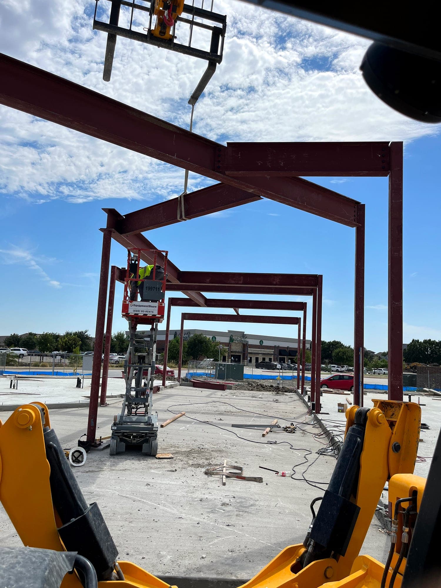 Crane setting a structural steel beam into place