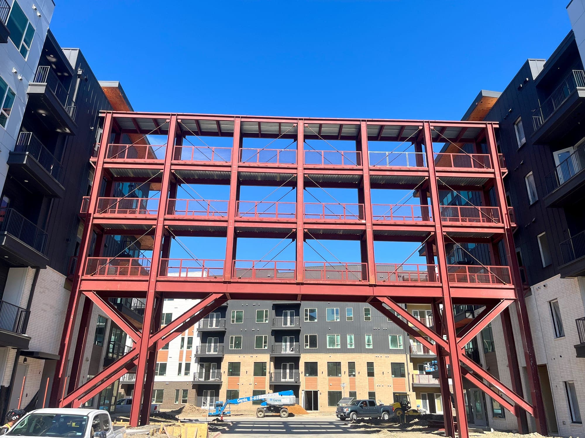 Structural steel frame erected in a multi-story residential courtyard