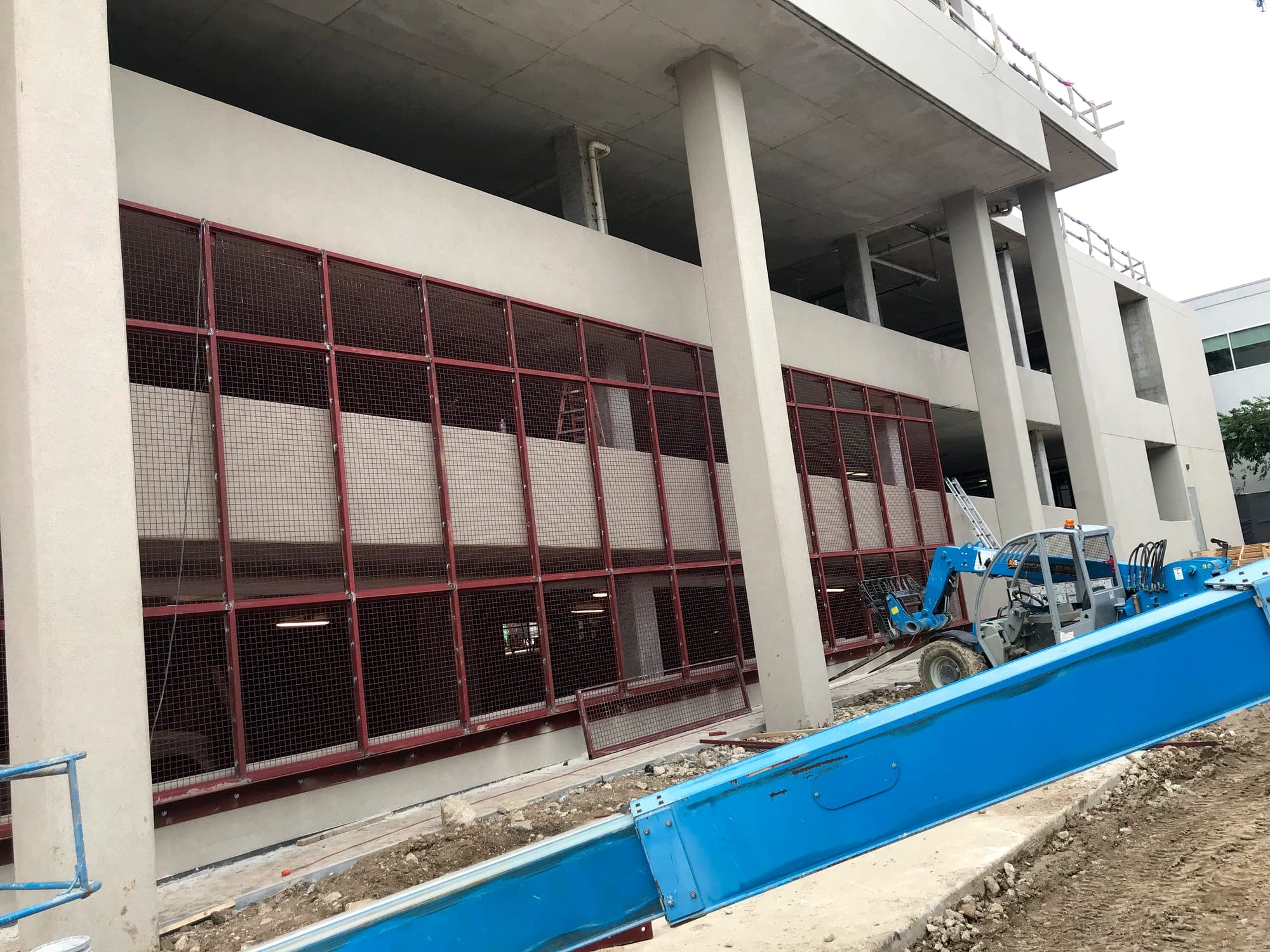 Steel screen framing installed across a parking structure facade