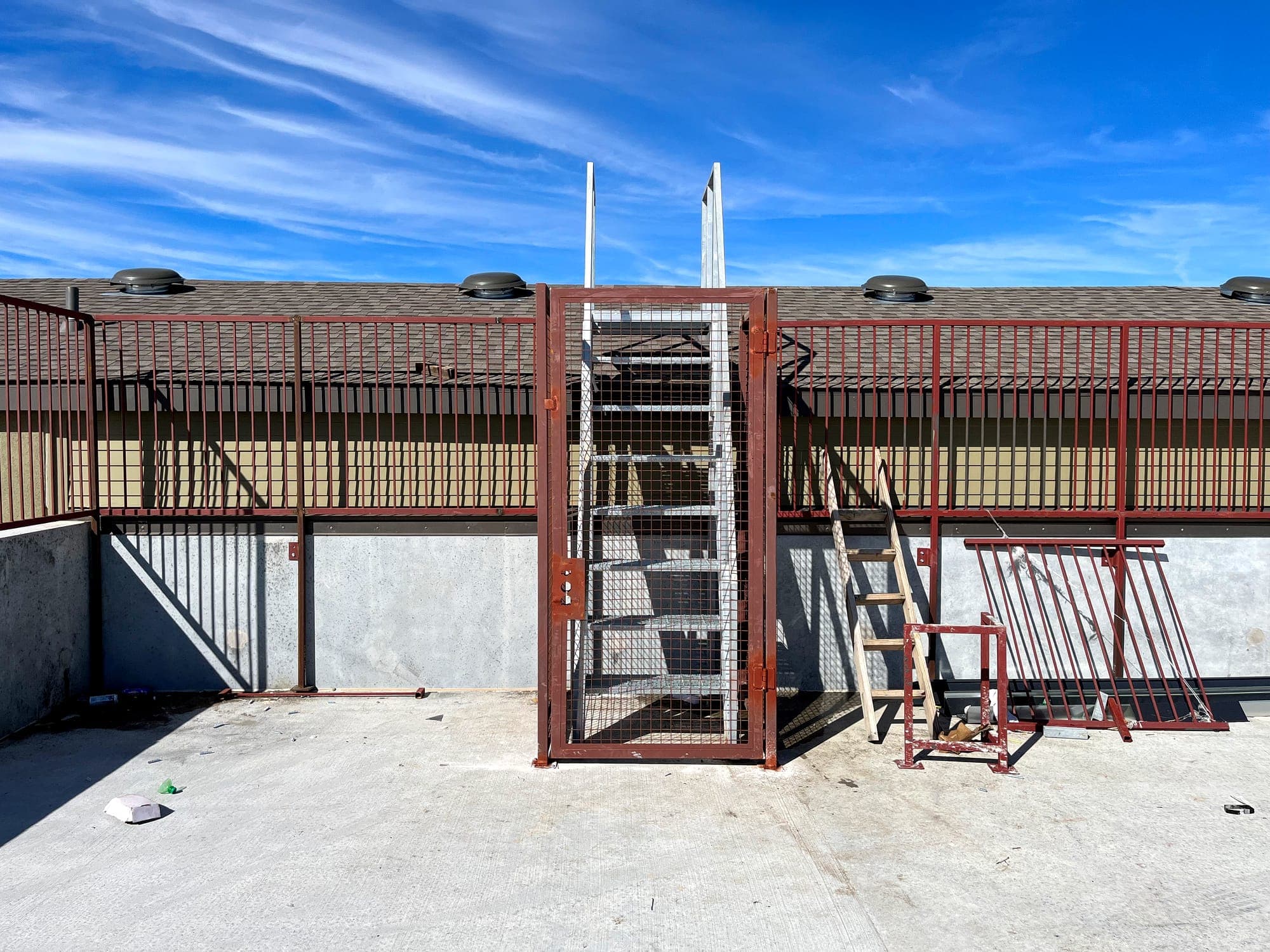 Steel roof screen wall with access stair and gate