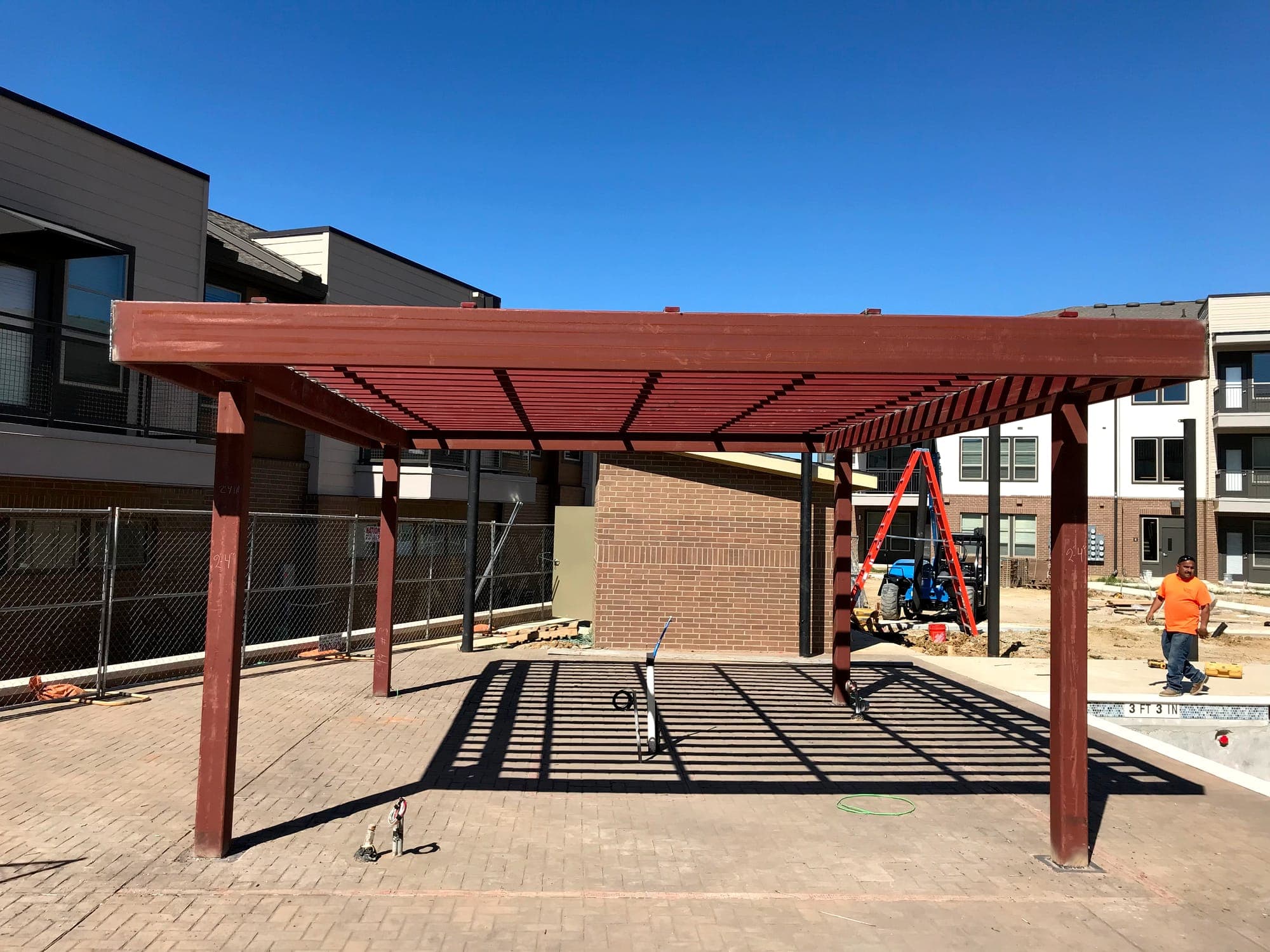 Steel shade structure erected in a residential courtyard